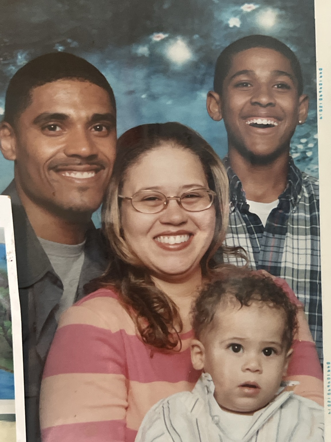 Family portrait β Edwin, Jaclynne, a teenage Javon smiling big, and baby Ja'Kari together as a family