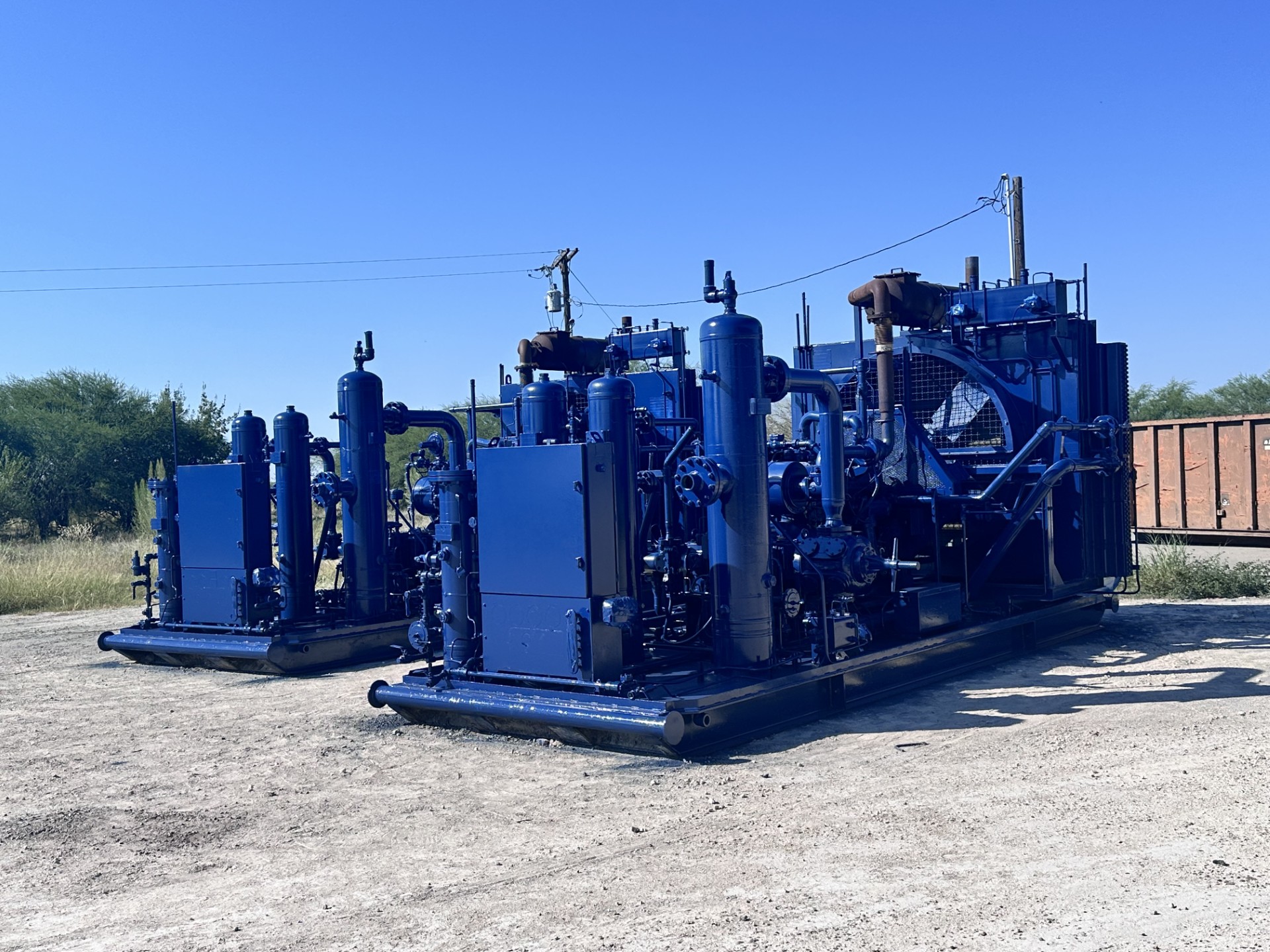 Multiple finished gas lift compressor packages outdoors