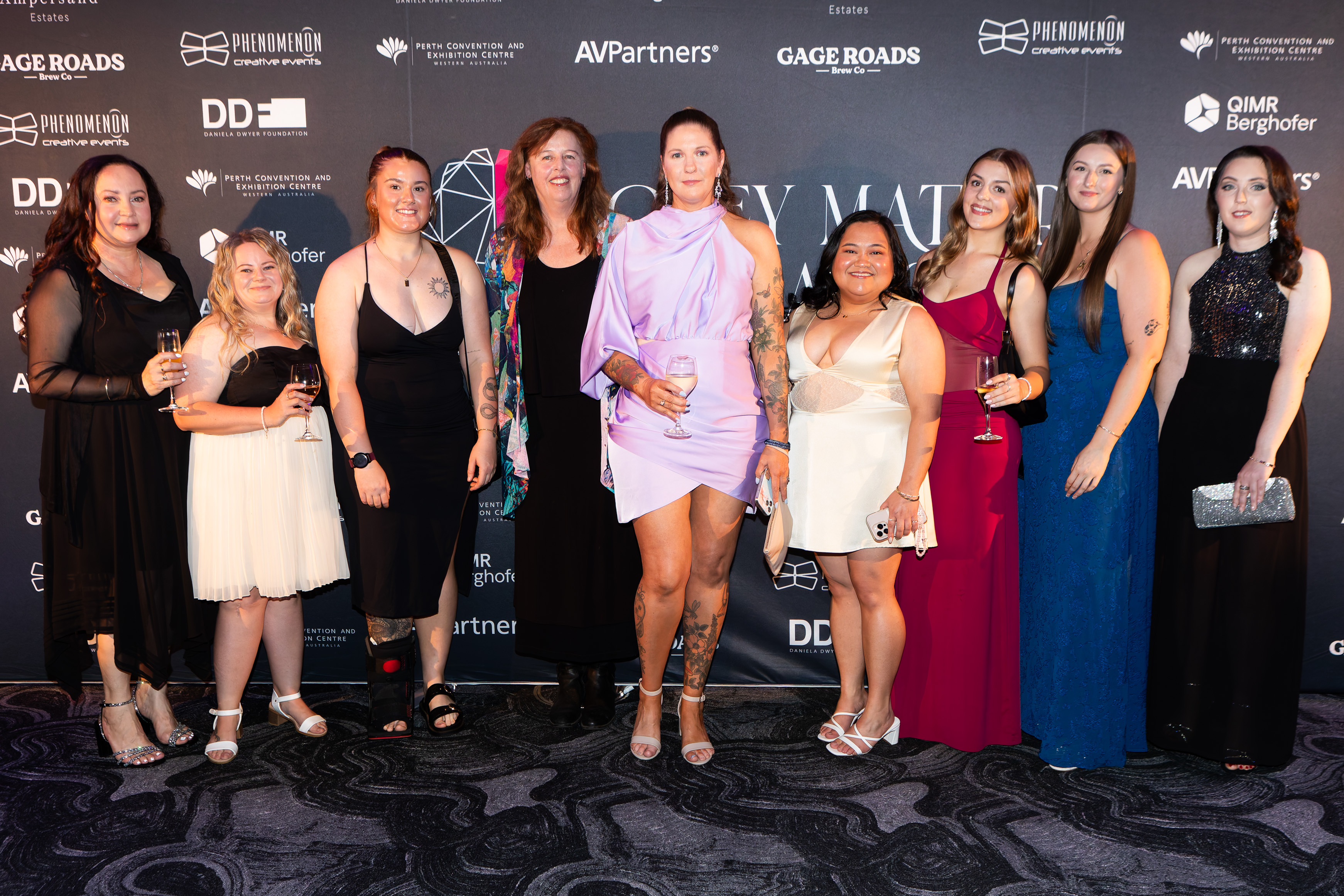 Group of friends at the sponsor wall at the Grey Matter Gala 2025