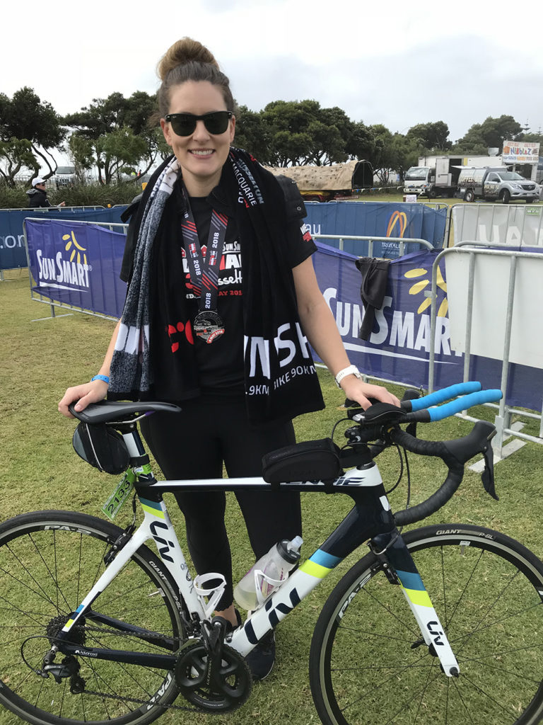 Dee at a triathlon event with her bike
