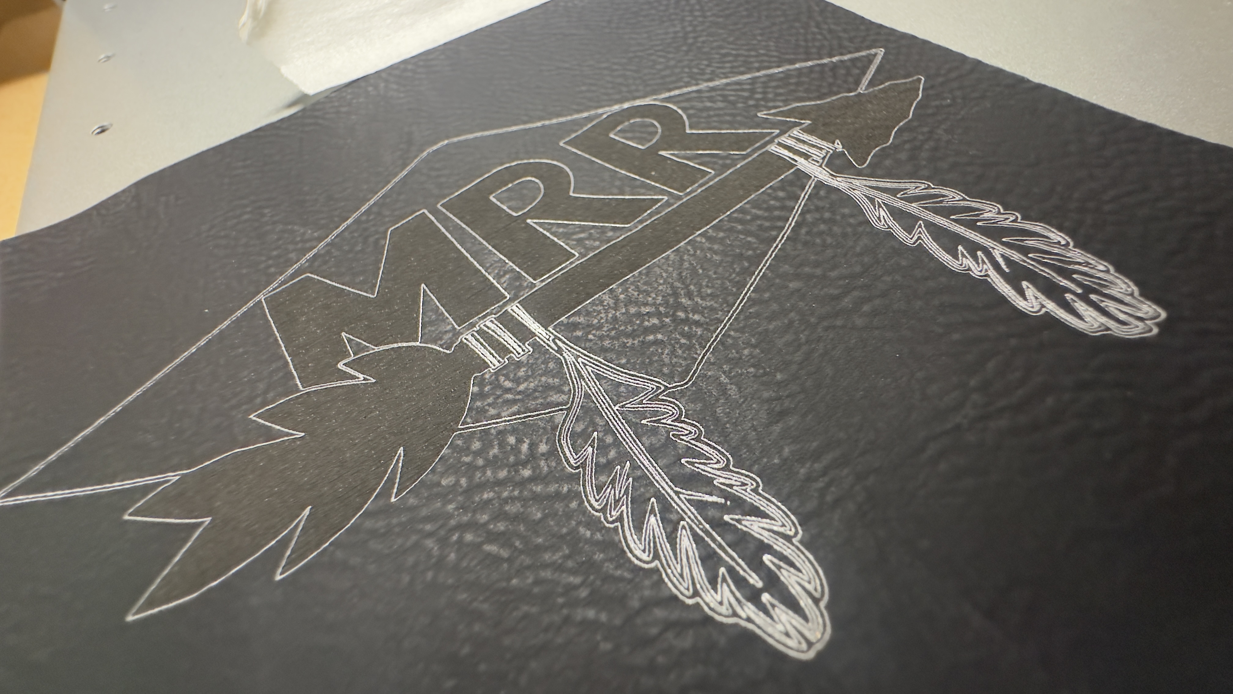MRR arrowhead logo laser-engraved on black leather