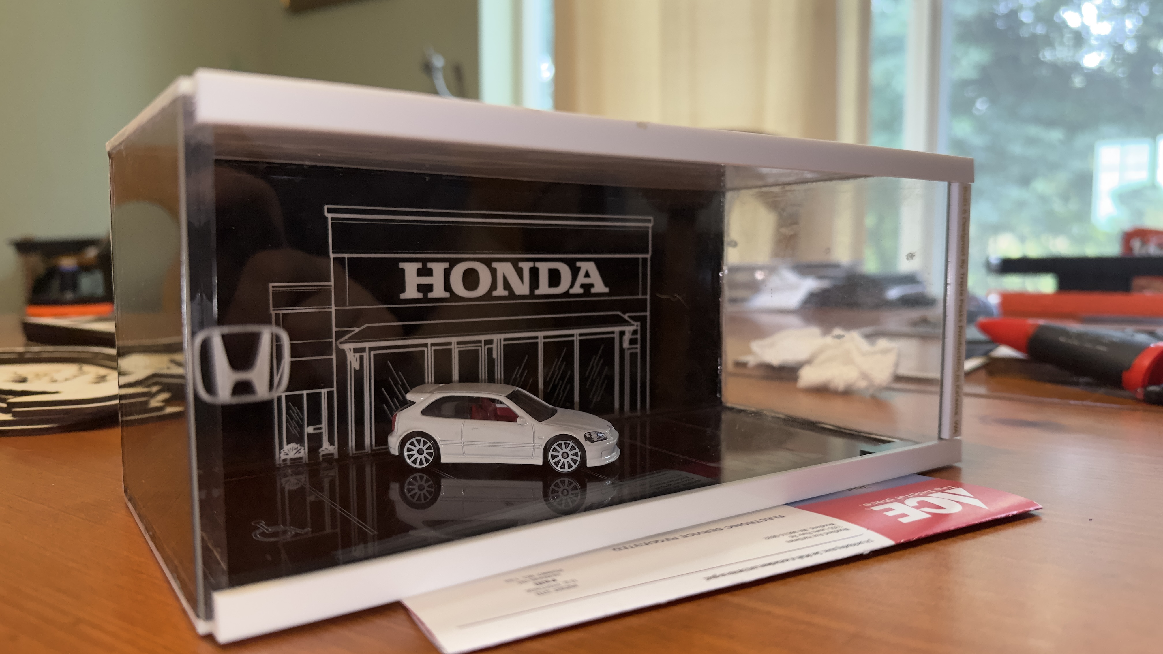 Acrylic diorama display case with laser-engraved Honda dealership backdrop and die-cast Civic Type R model car inside