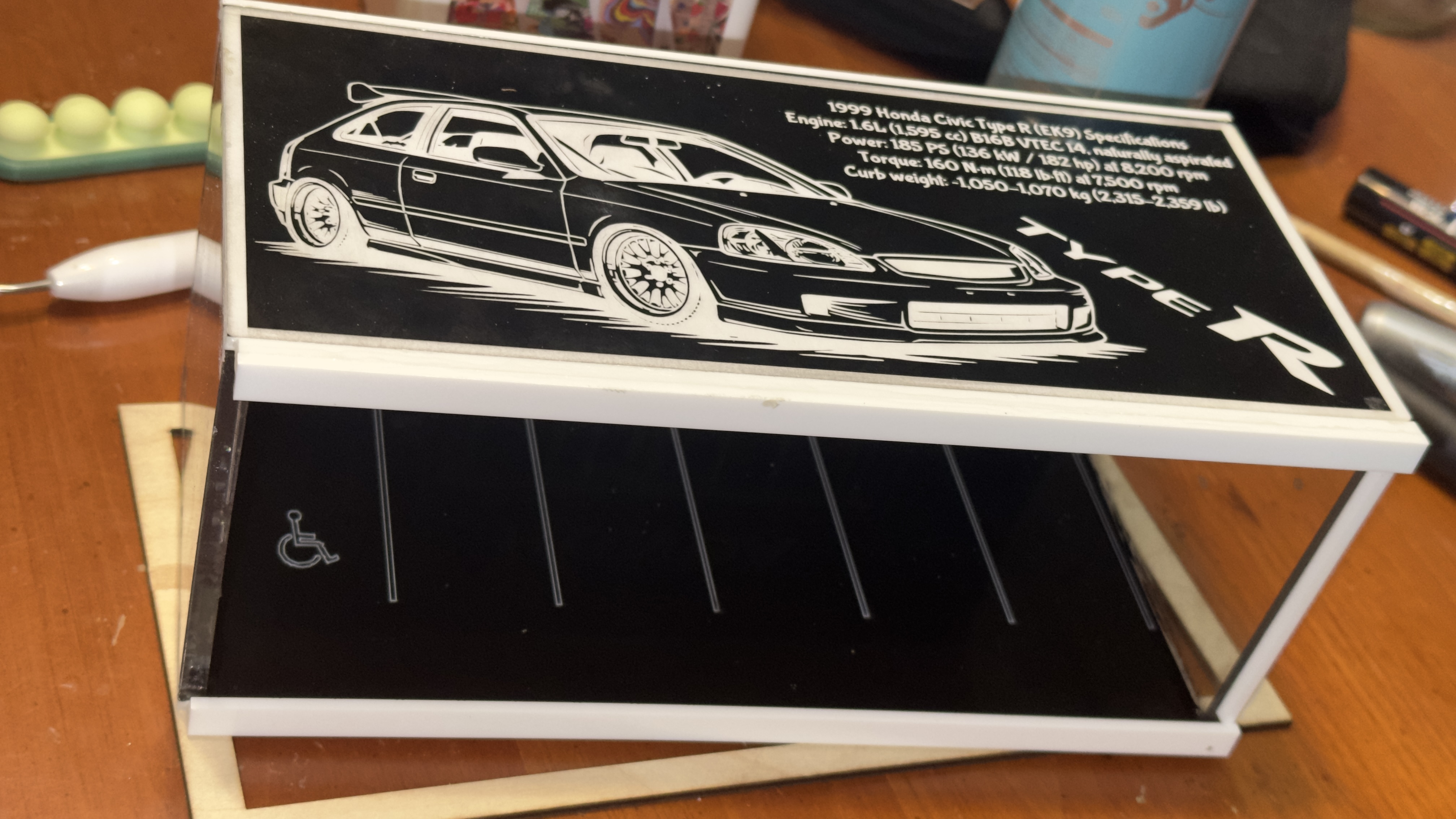 Assembled acrylic diorama showing laser-engraved Honda Civic Type R spec sheet panel and dealership parking lot base