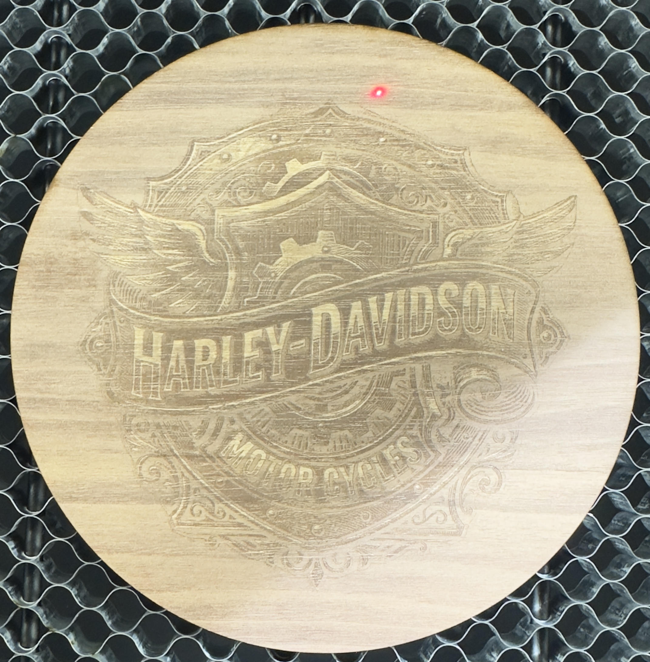 Laser-engraved wood round with detailed Harley-Davidson design