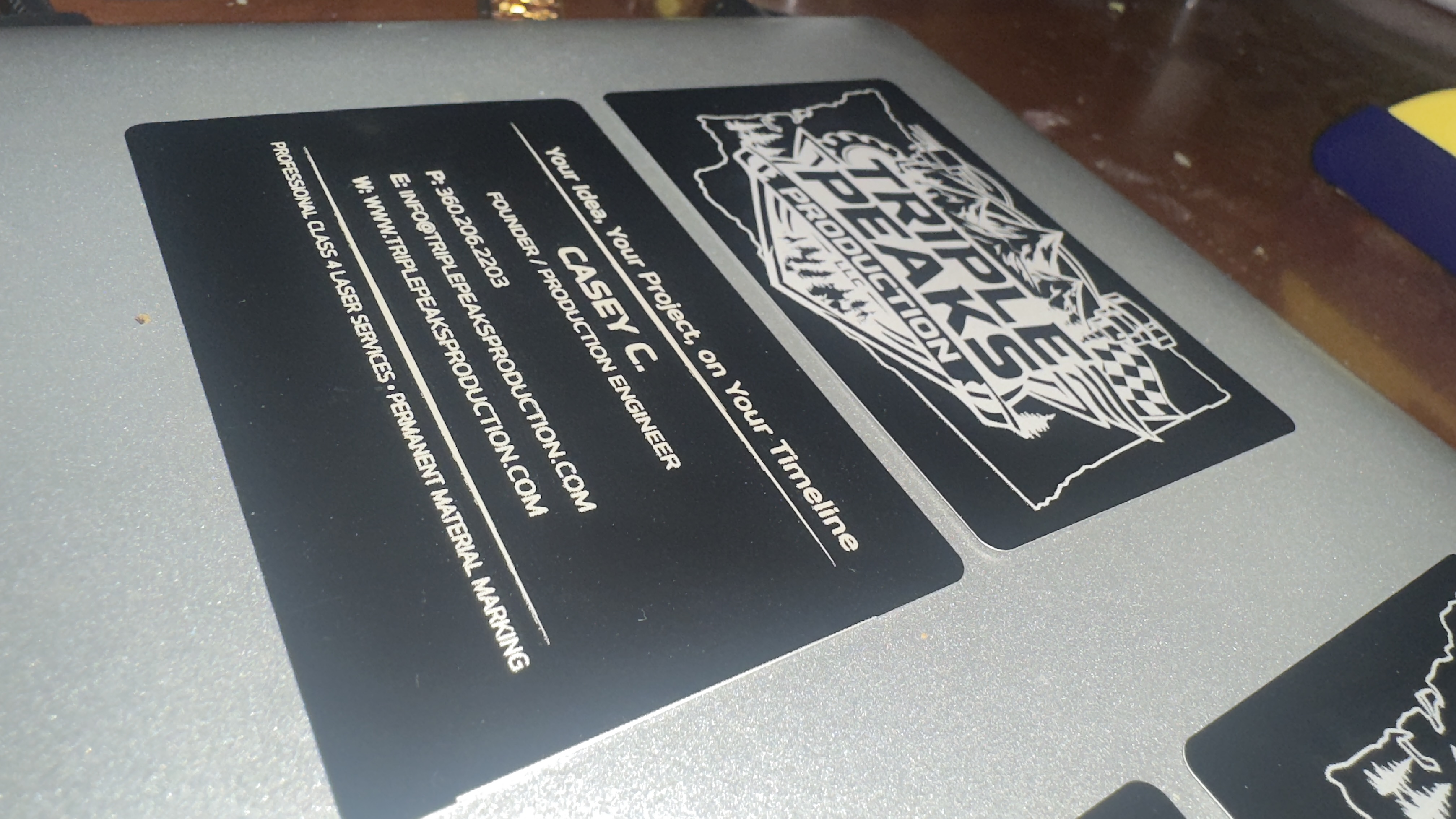 Triple Peaks Production metal business cards  front and back side by side