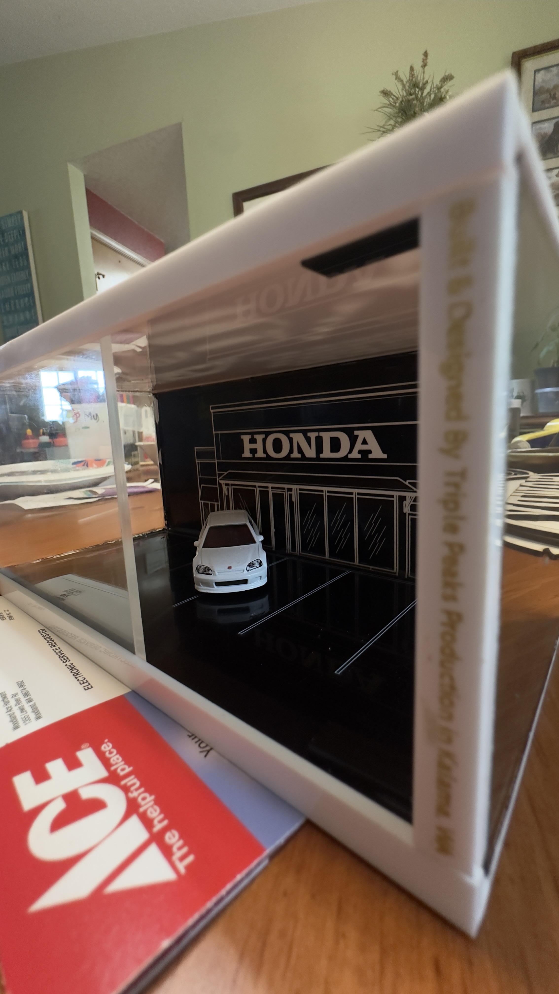 Front angle view of acrylic Honda dealership diorama display with die-cast Civic Type R and Triple Peaks Production branding on the side