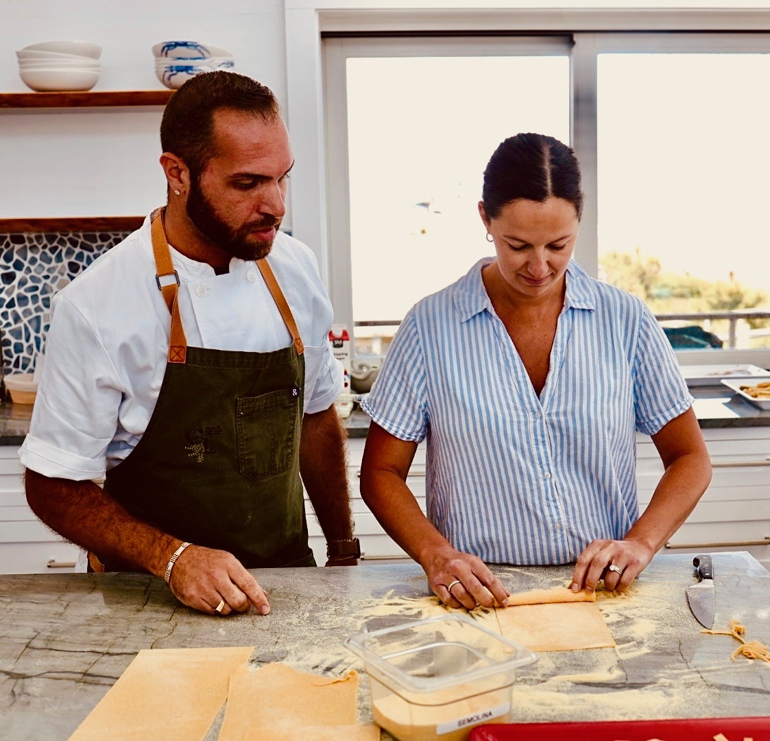 Chef Francesco La Russa teaching a guest to hand-roll pasta at a private cooking class in Montauk