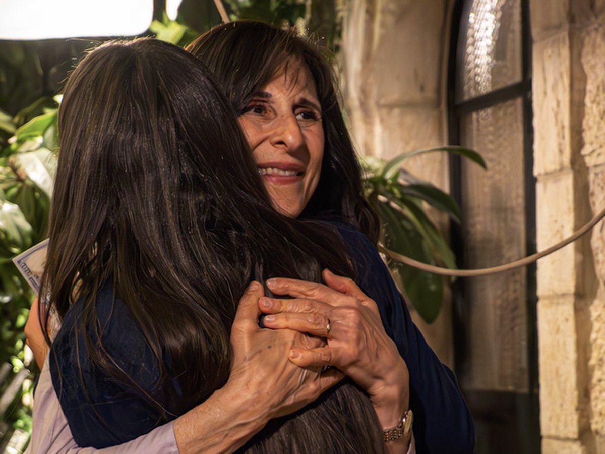 Two women embracing at the mission trip dinner