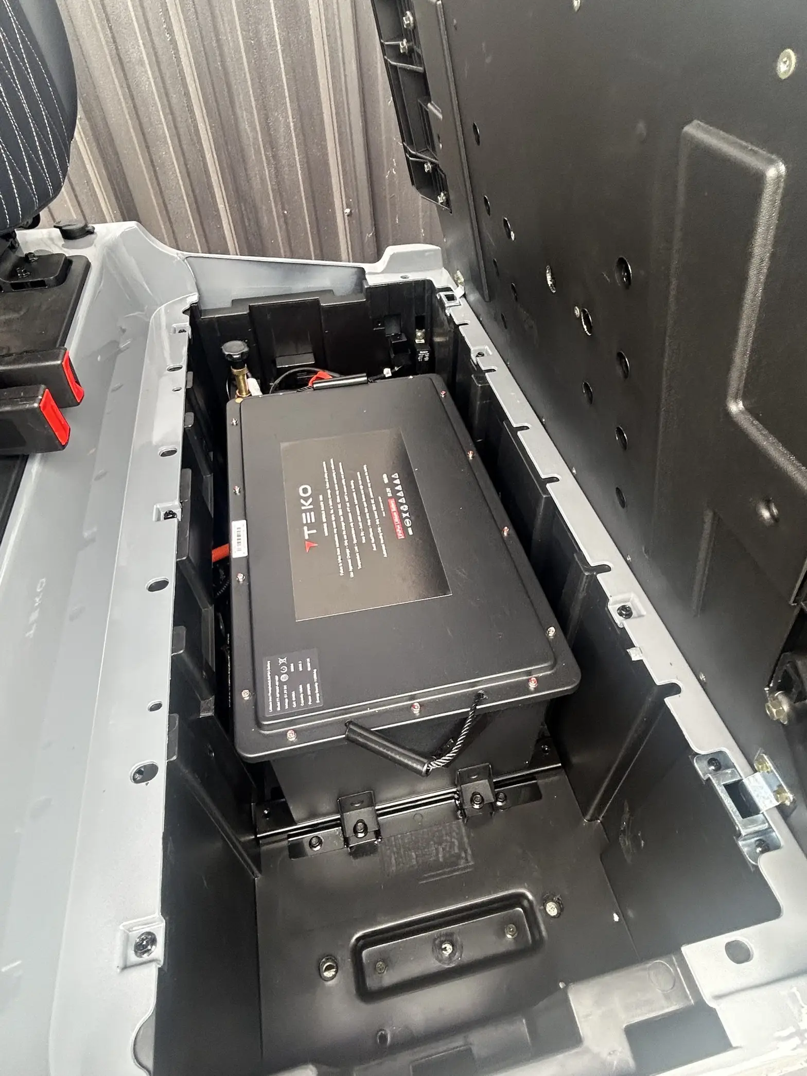 Teko lithium battery installed in a golf cart battery compartment