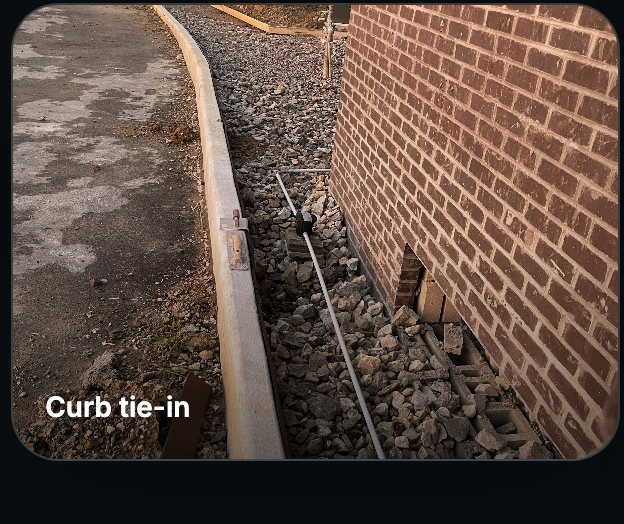 Concrete curb tie-in along a building with gravel drainage in Columbus Ohio