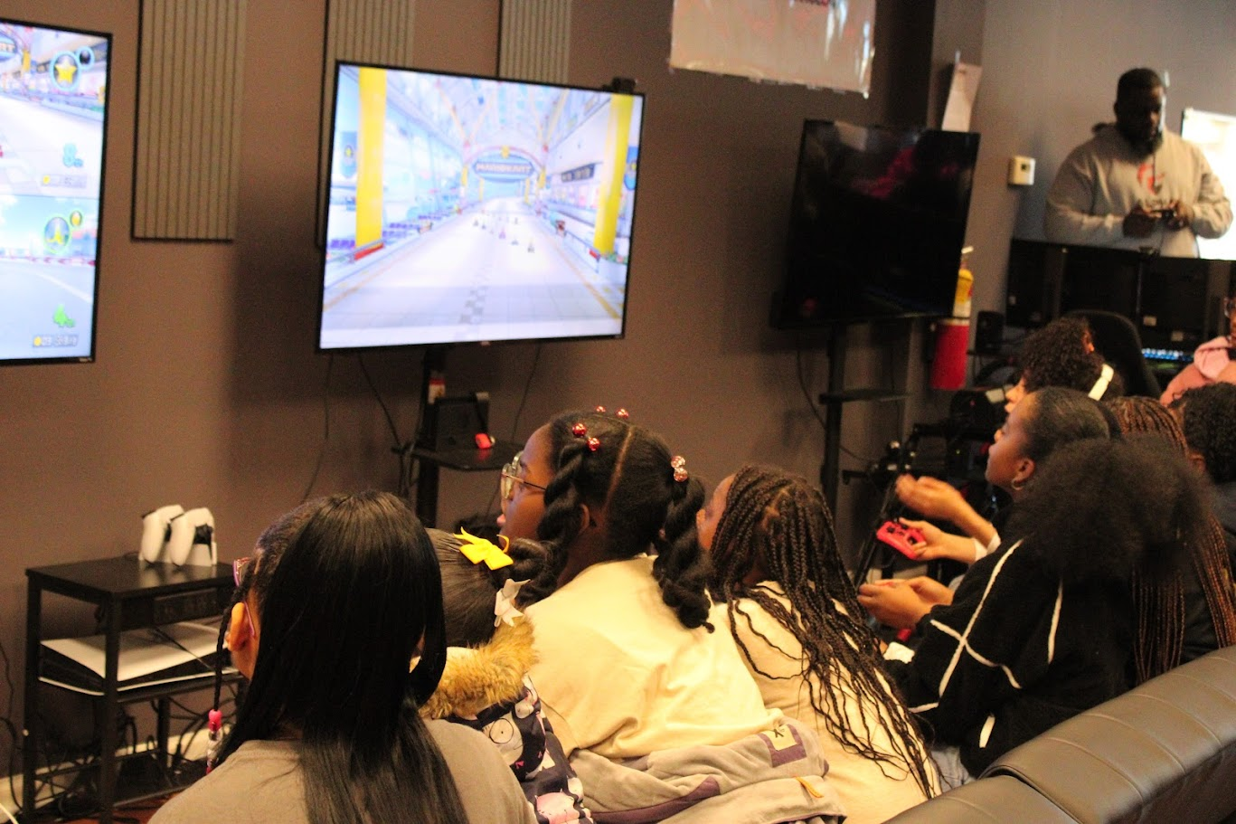 Girls playing Mario Kart together at a Girls Game Too meetup at Alpha Esports & Technology