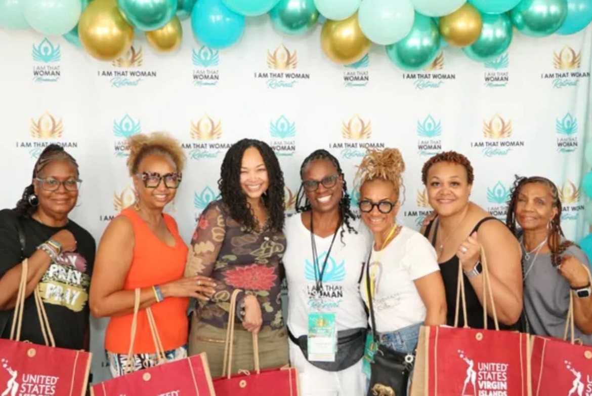 Group photo with swag bags at the 2024 USVI Retreat step-and-repeat backdrop