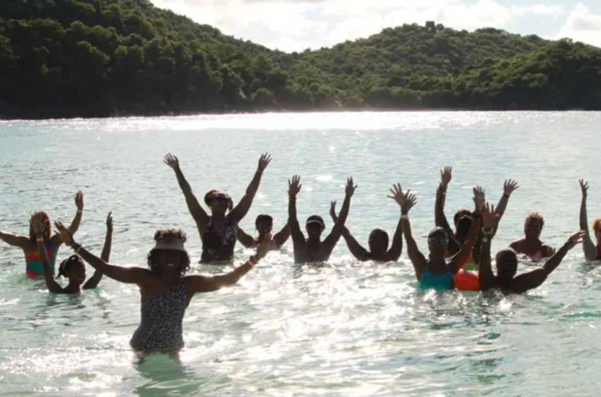 Women in the ocean with hands raised celebrating in the US Virgin Islands