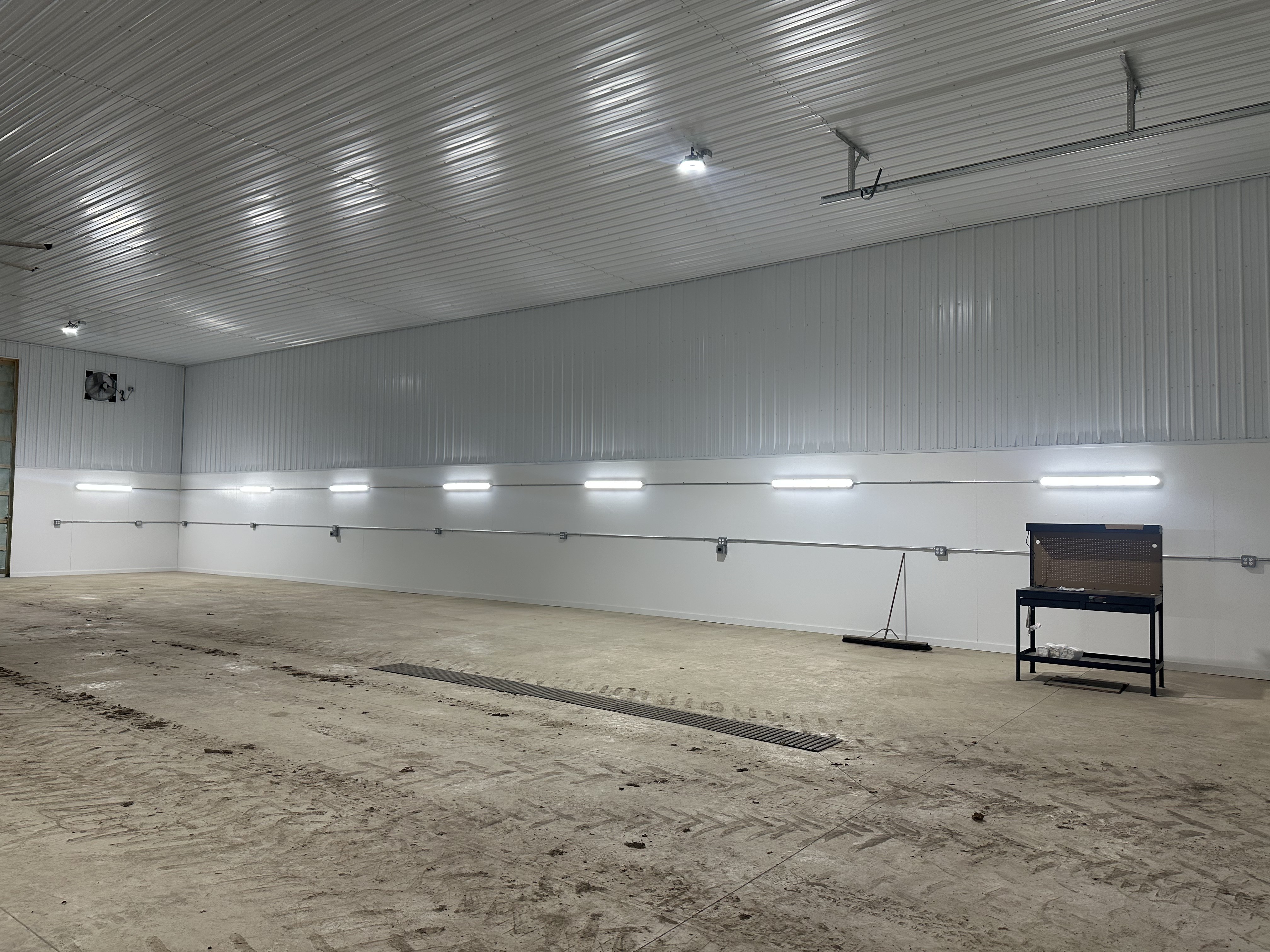 Commercial metal building with LED wall mount and high-bay lighting by Premier Alarms and Electric โ Monroe County NY