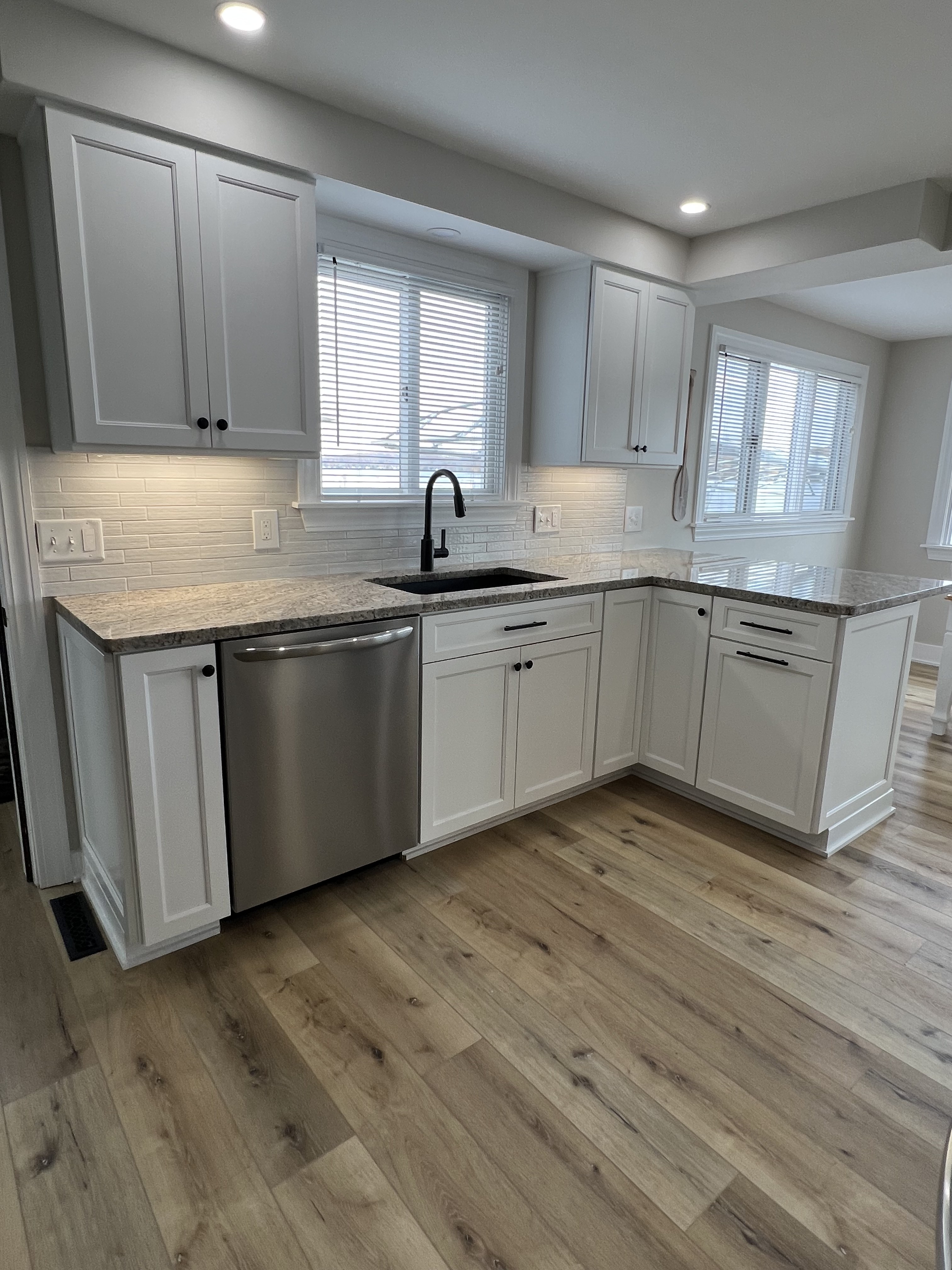 Completed kitchen remodel with under-cabinet LED lighting and recessed ceiling lights by Premier Alarms and Electric โ Rochester NY