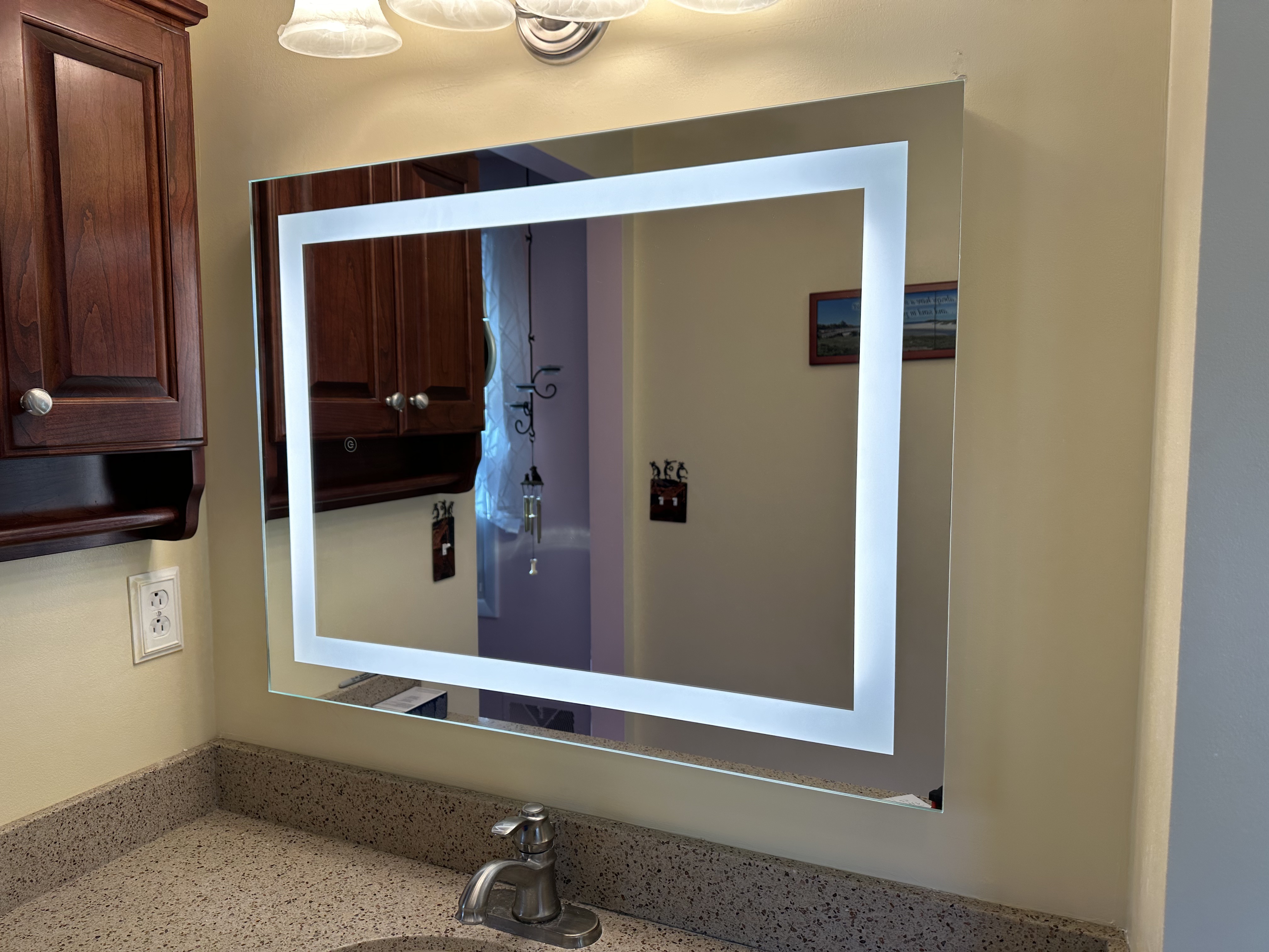 Backlit LED mirror installation in bathroom by Premier Electric Rochester NY