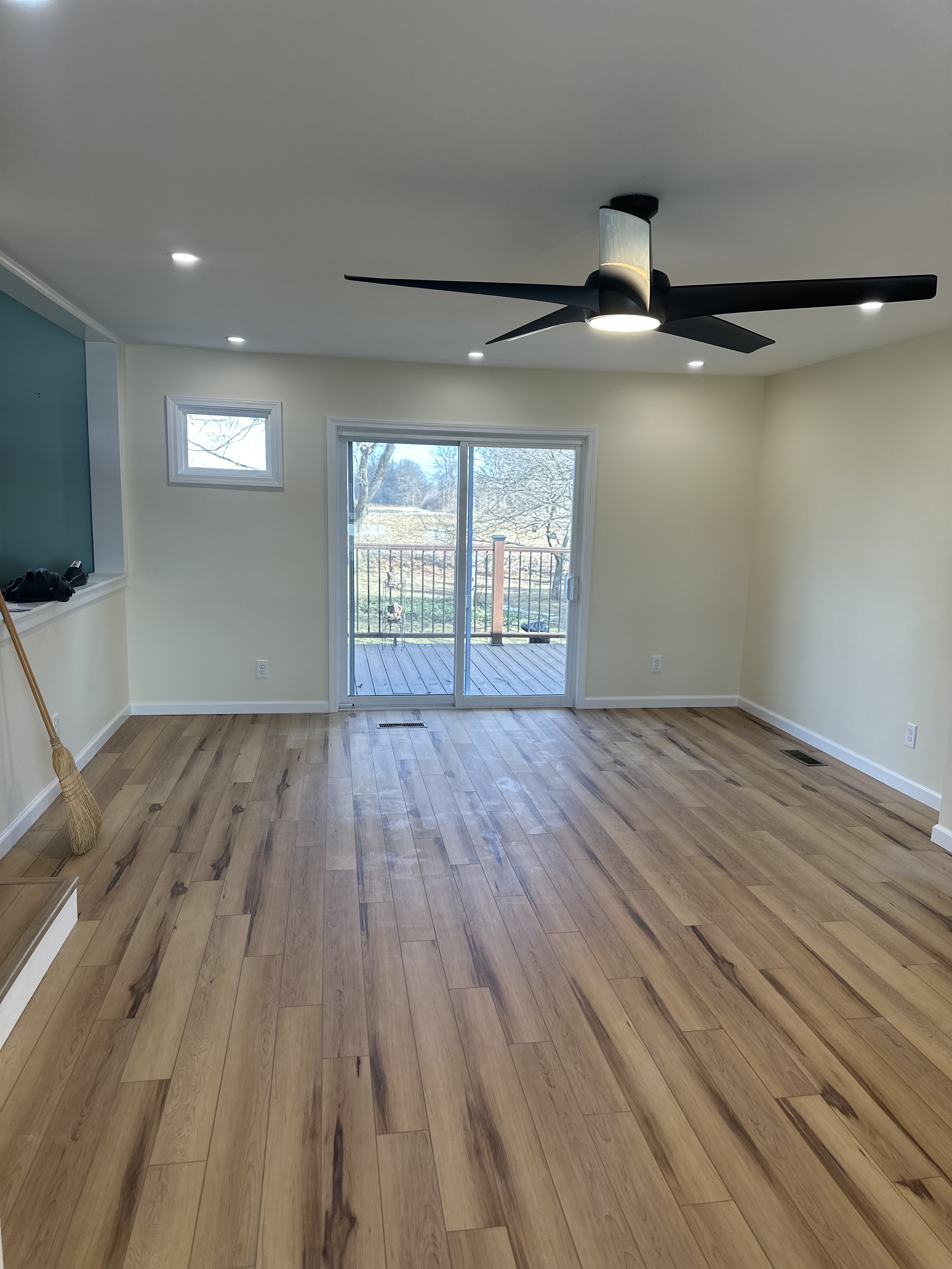 Beautifully renovated living room with recessed LED lighting and modern ceiling fan installed by Premier Alarms and Electric โ Monroe County NY