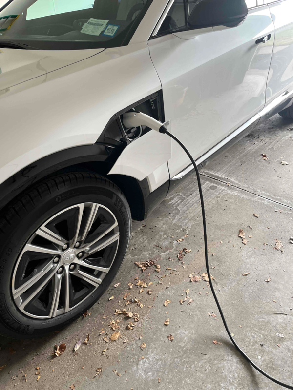 EV charger installation with luxury SUV by Premier Electric Rochester NY