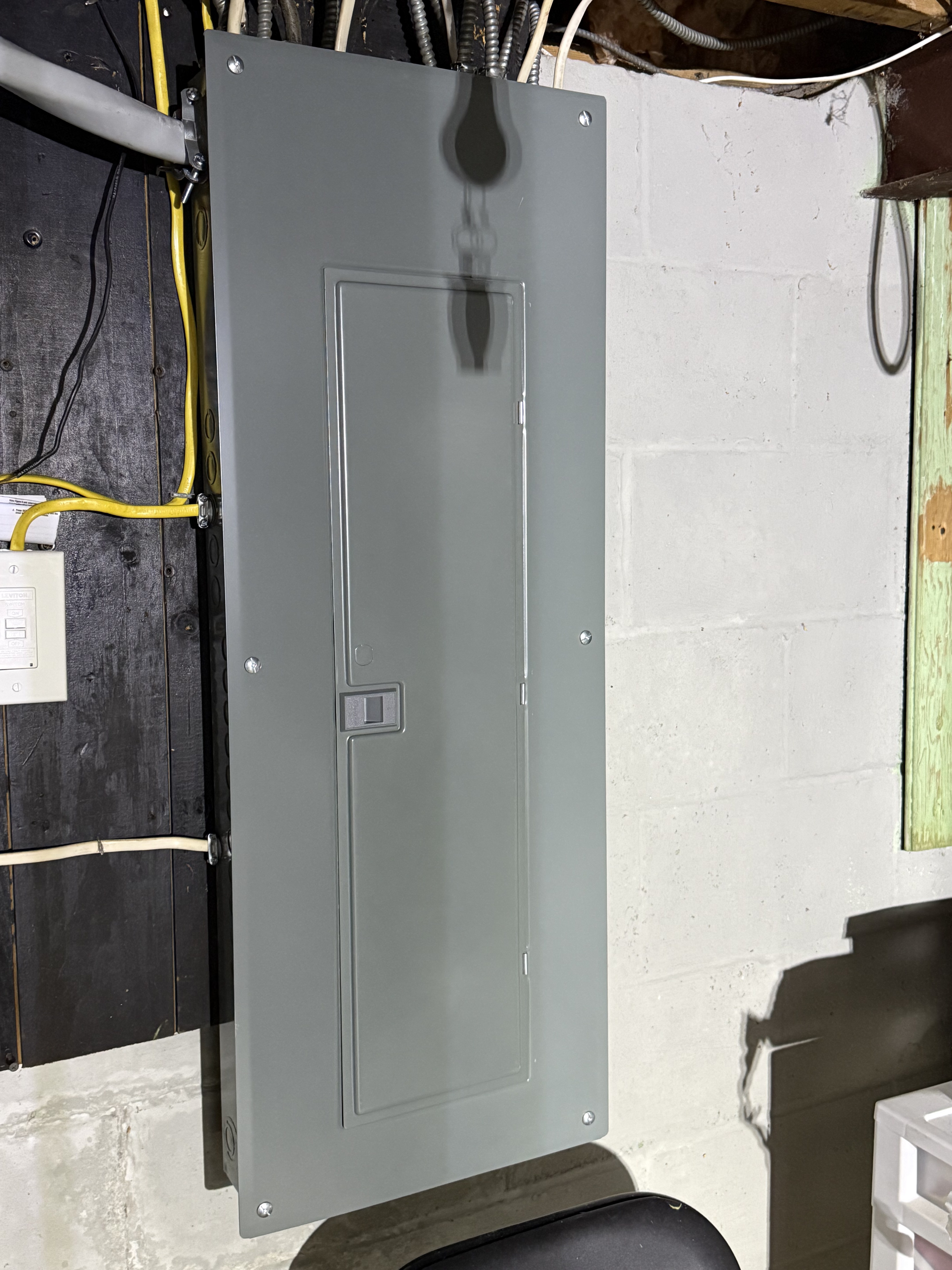 New 200-amp Square D electrical panel installed with armored cable runs in Rochester NY basement by Premier Alarms and Electric