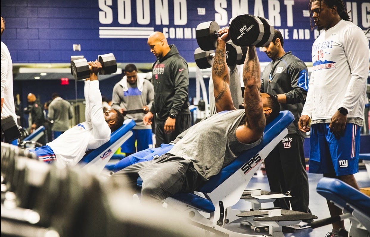 Pratik Patel working with players in the New York Giants weight room
