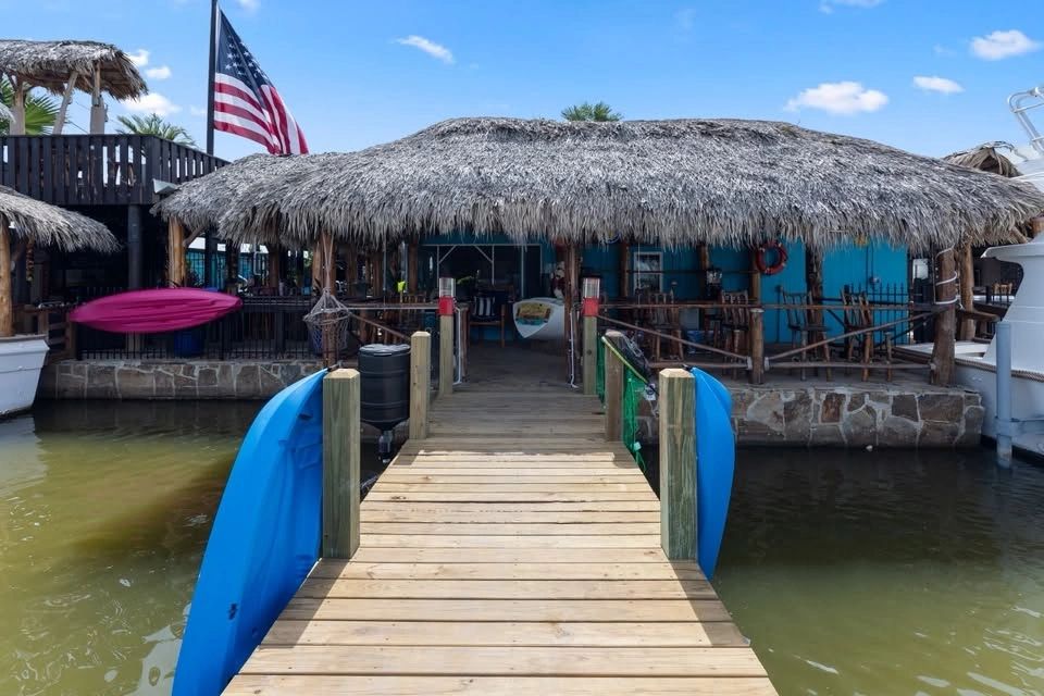 Wooden pier leading to the Crazy Crab Shack over the water in Sargent, Texas