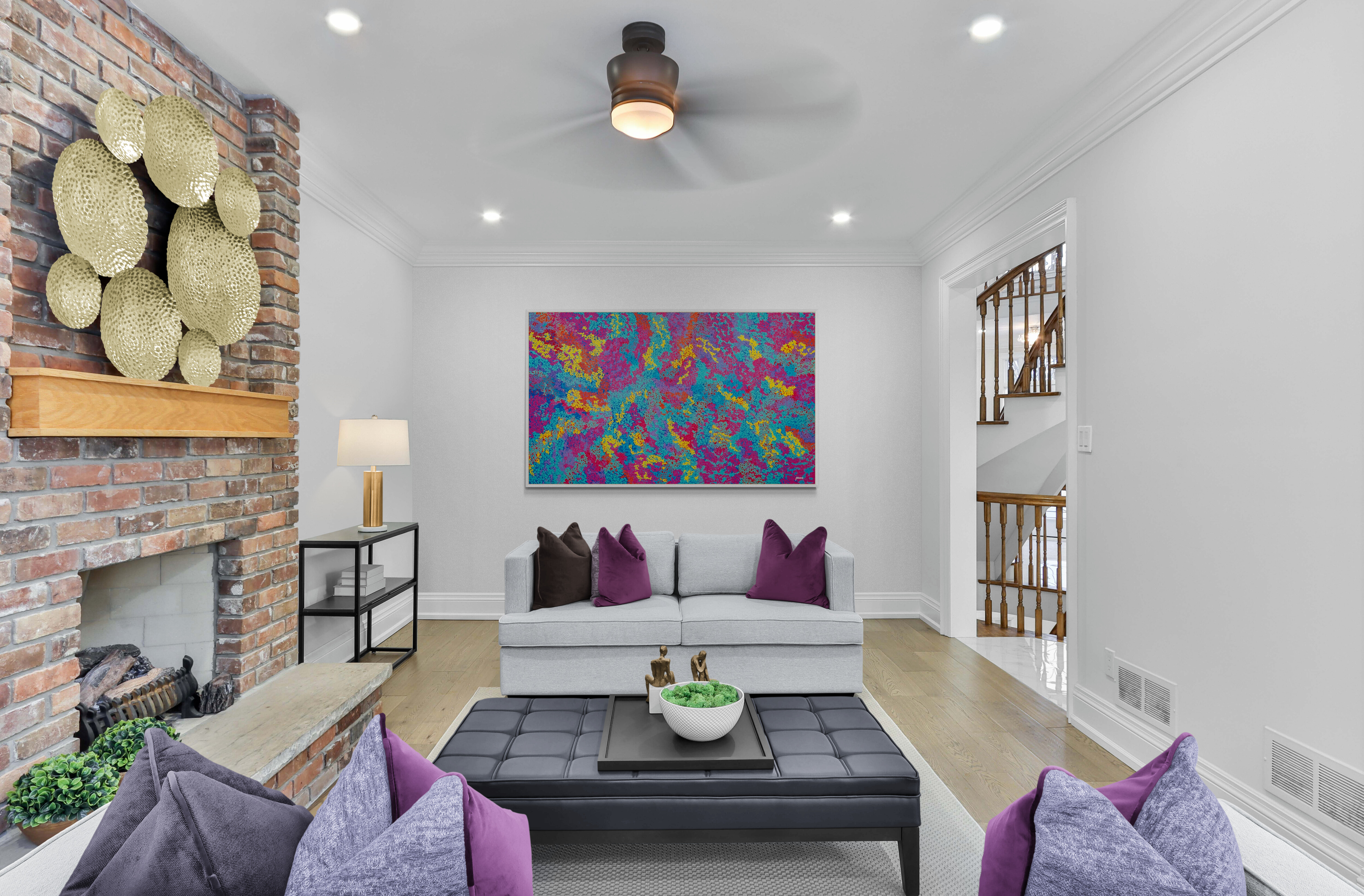 Colourful Aboriginal art in contemporary living room with fireplace