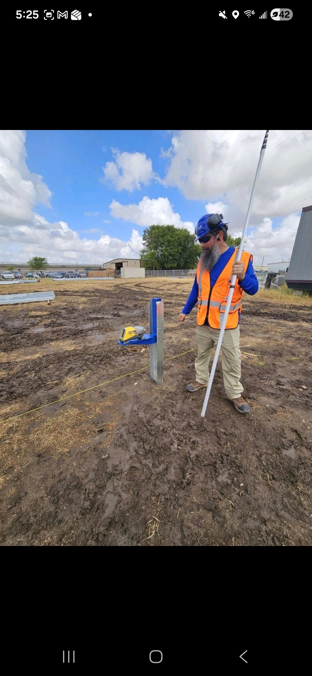 Blue Sky team member surveying a solar construction site