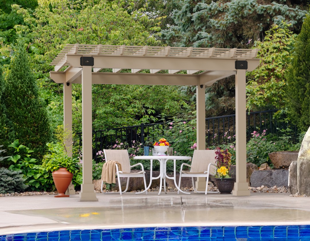 Clay vinyl Hollander pergola with black brackets beside a pool, with a bistro table and two chairs underneath