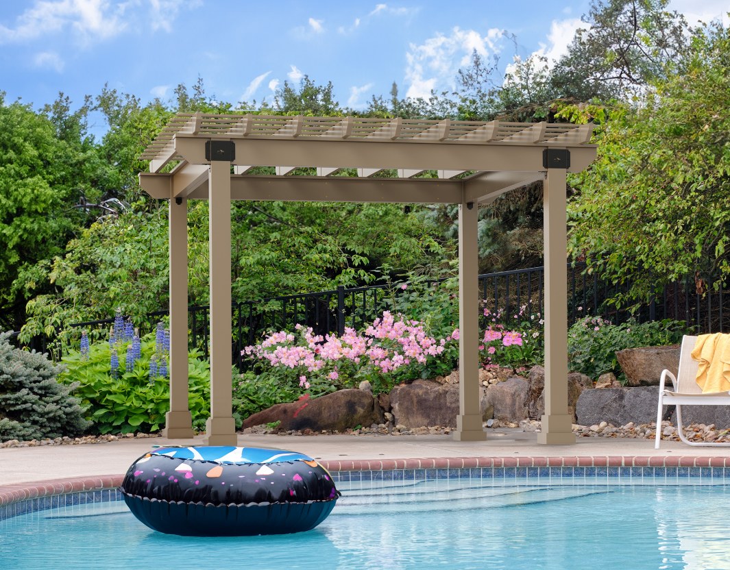 Tan vinyl Hollander pergola at the edge of a pool, with a pool float in the foreground