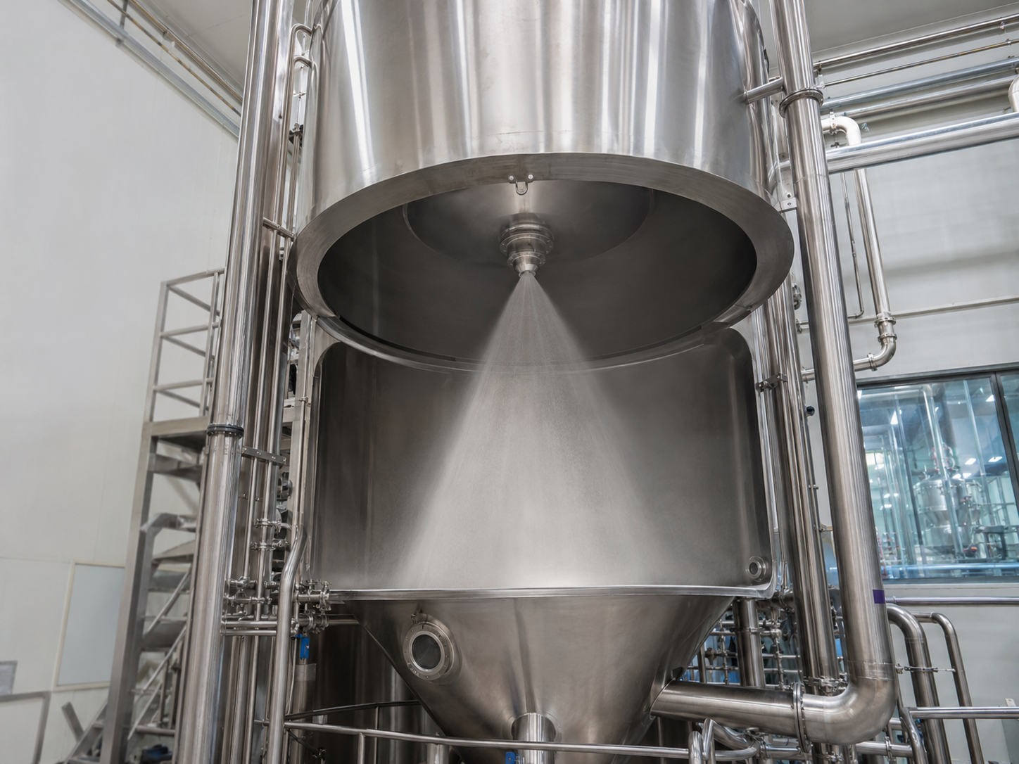 Industrial spray drying equipment in a manufacturing facility