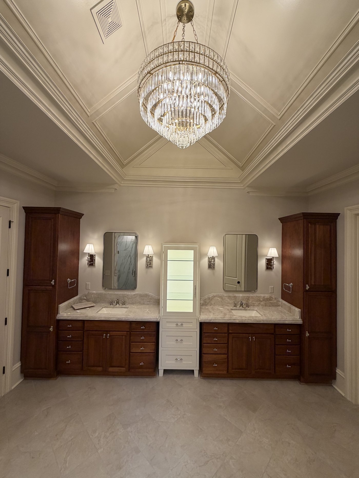 Master bath with double cherry vanities, crystal chandelier and coffered ceiling