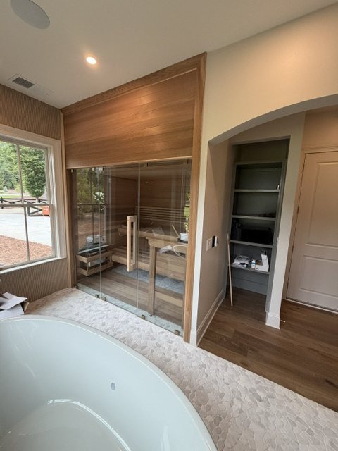 Spa suite with glass-front cedar sauna and soaking tub