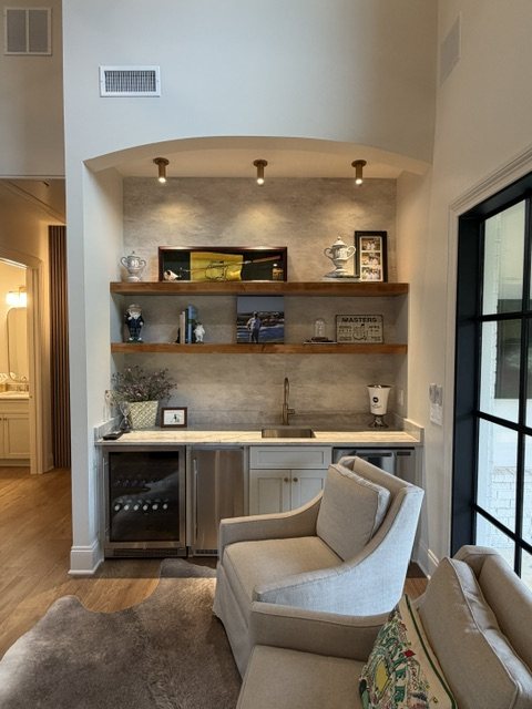 Custom wet bar with wine cooler and floating wood shelves