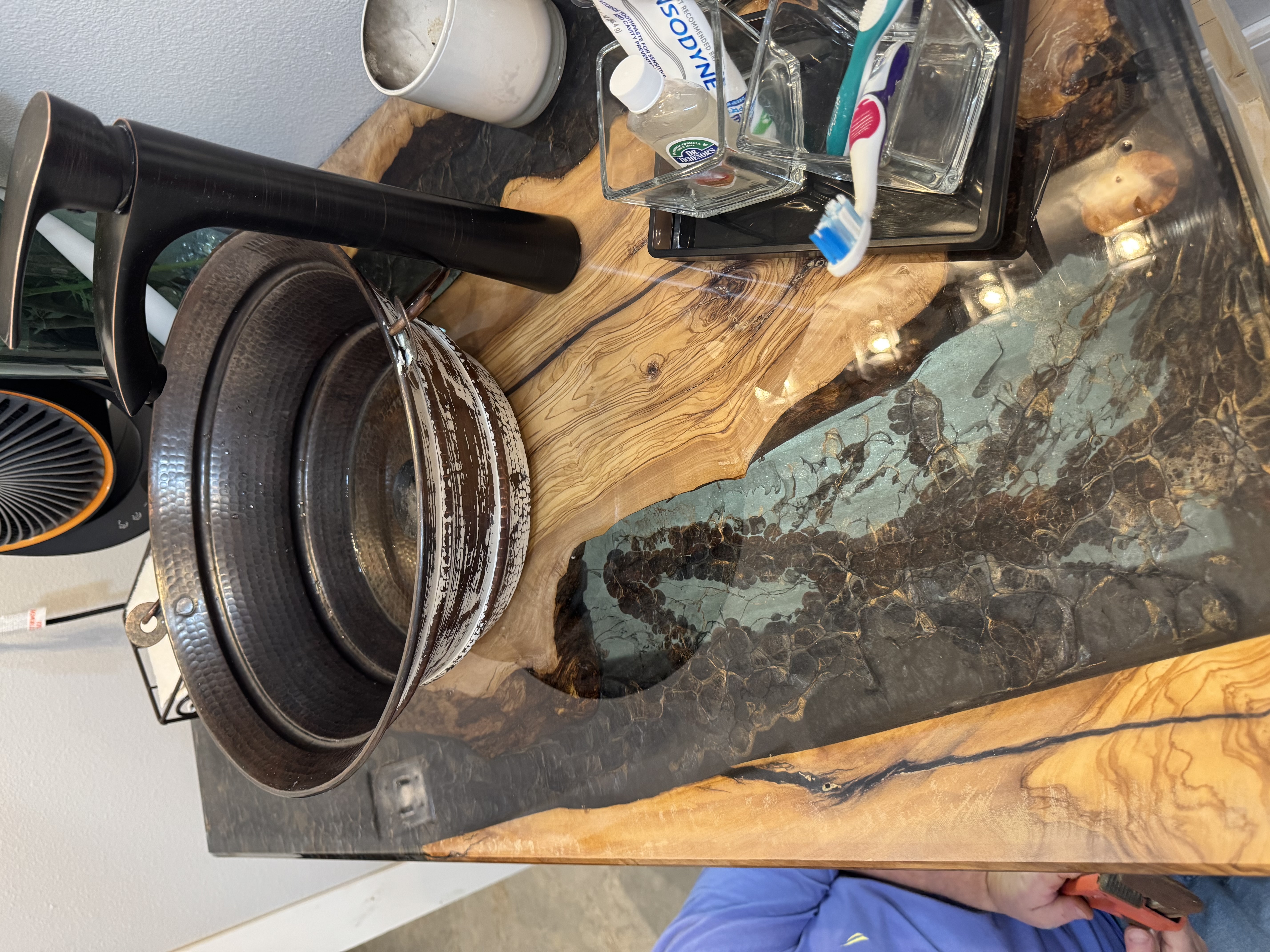 Live edge epoxy vanity countertop with hammered copper vessel sink custom built in Abita Springs