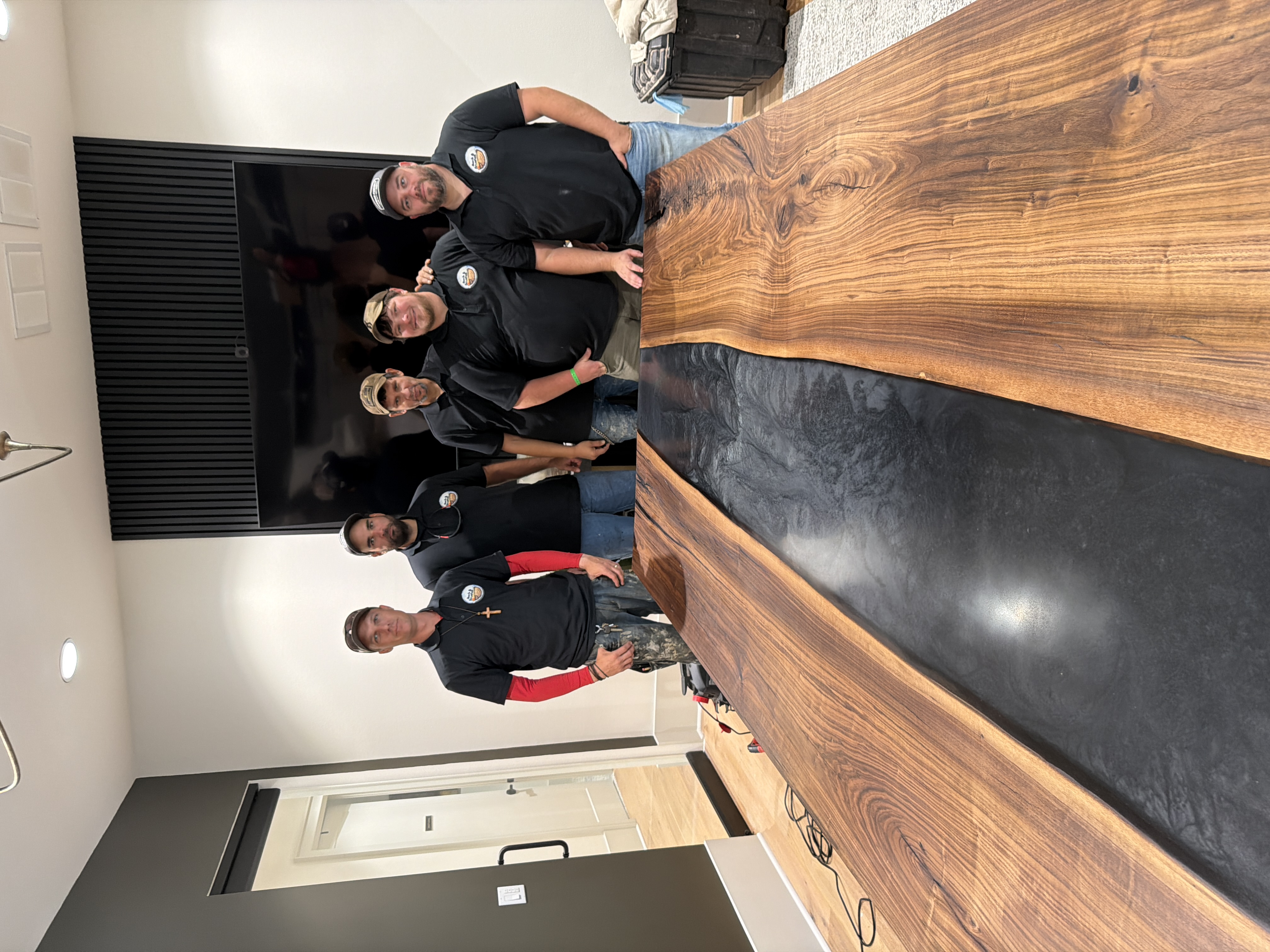 Bark and Brushes team delivering massive walnut epoxy river conference table to Covington office