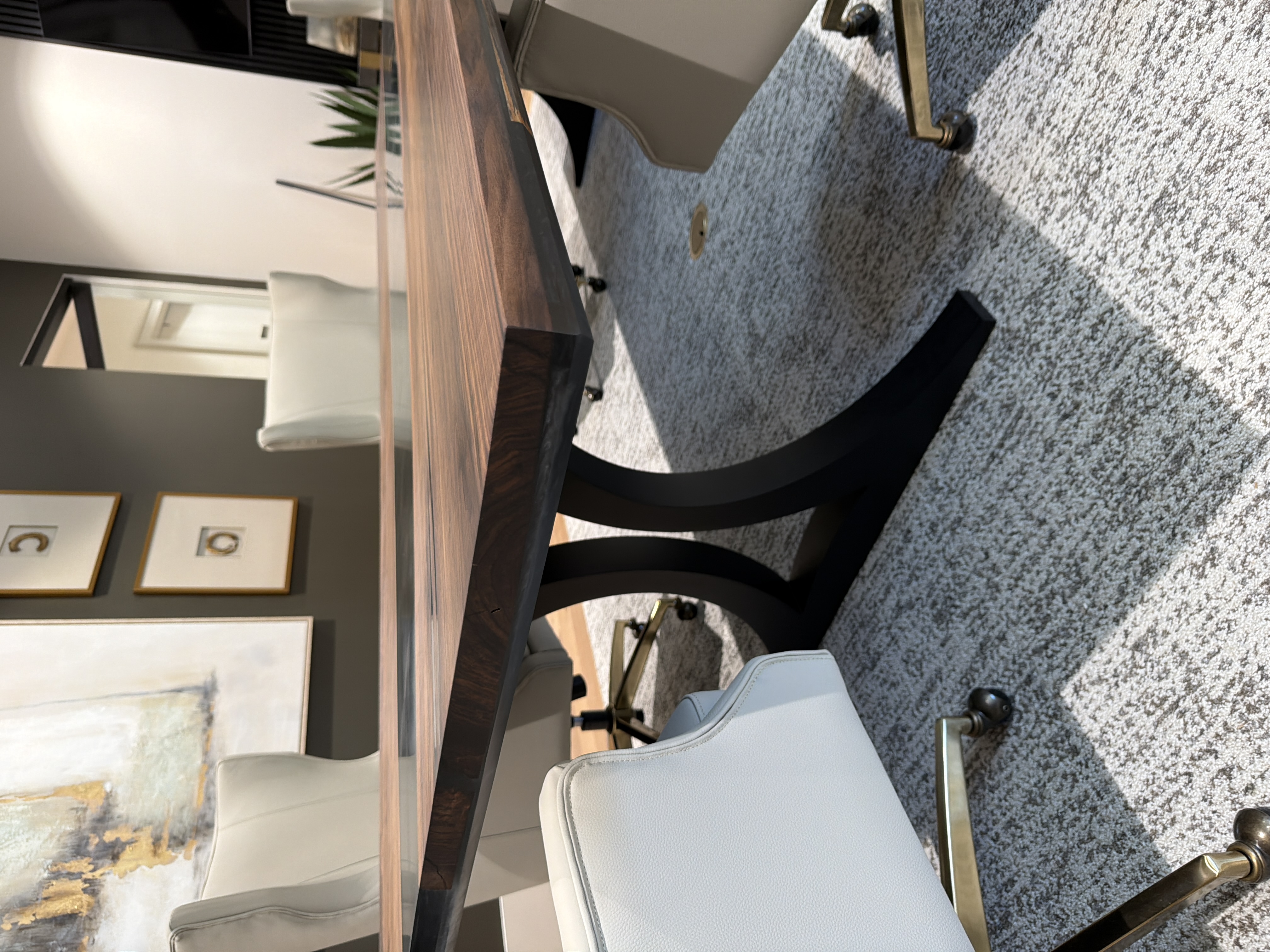 Conference table detail showing curved black metal base and walnut top custom furniture Louisiana