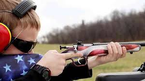Youth smallbore rifle shooter in action