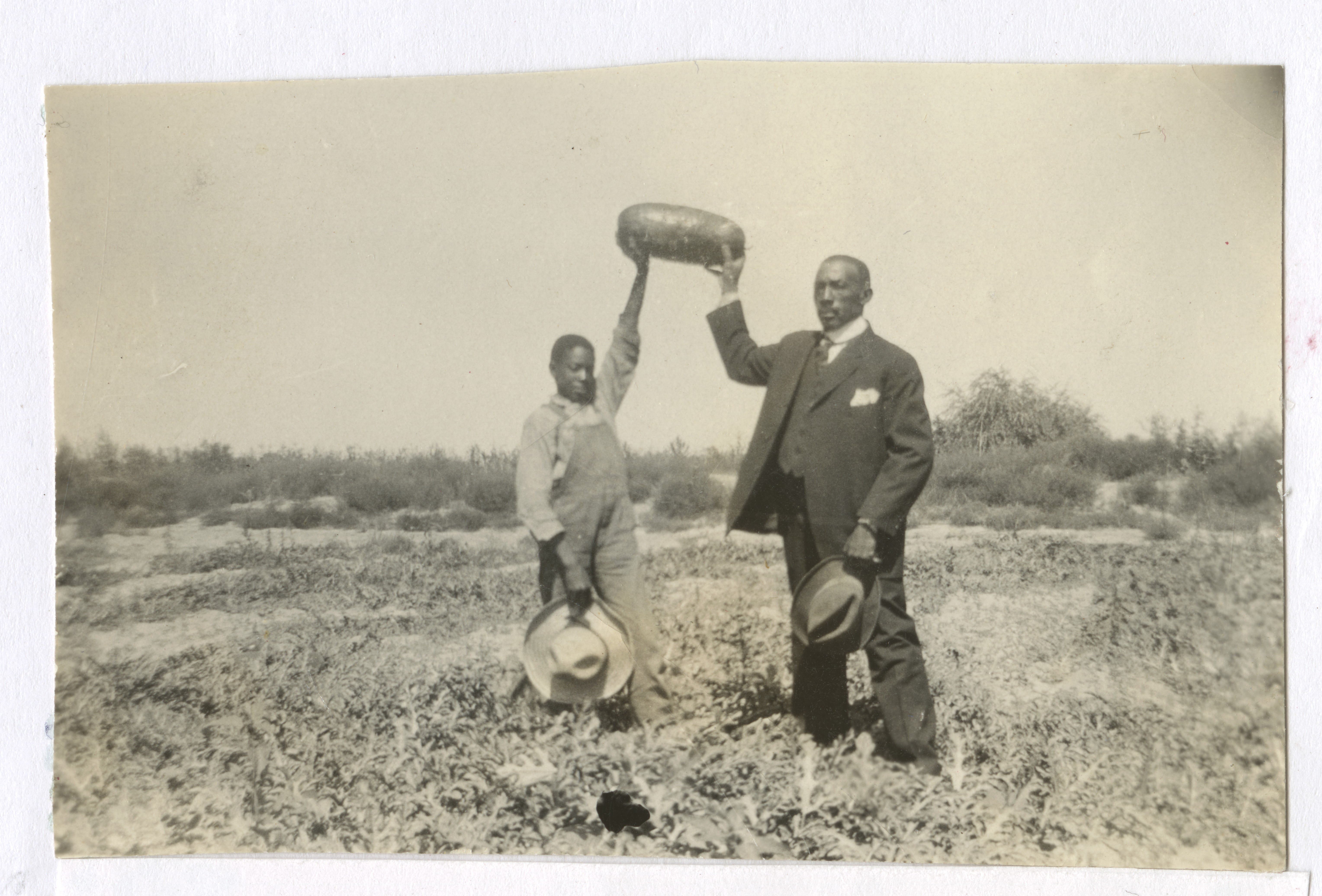 Ford and Crawford Hicks standing in a field on the homestead