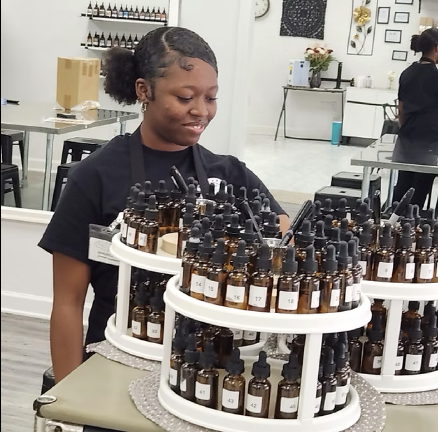 Youth apprentice working with essential oils at partner business
