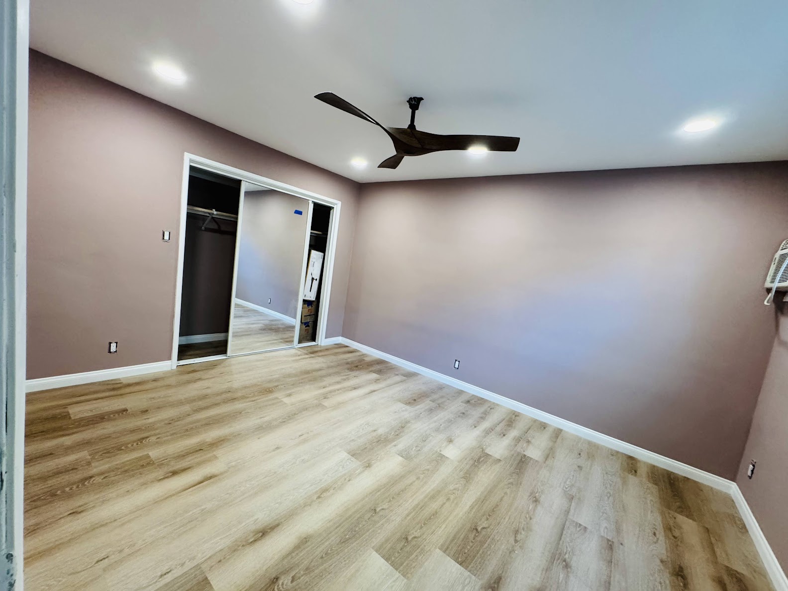 Interior painting - bedroom with accent wall and ceiling fan