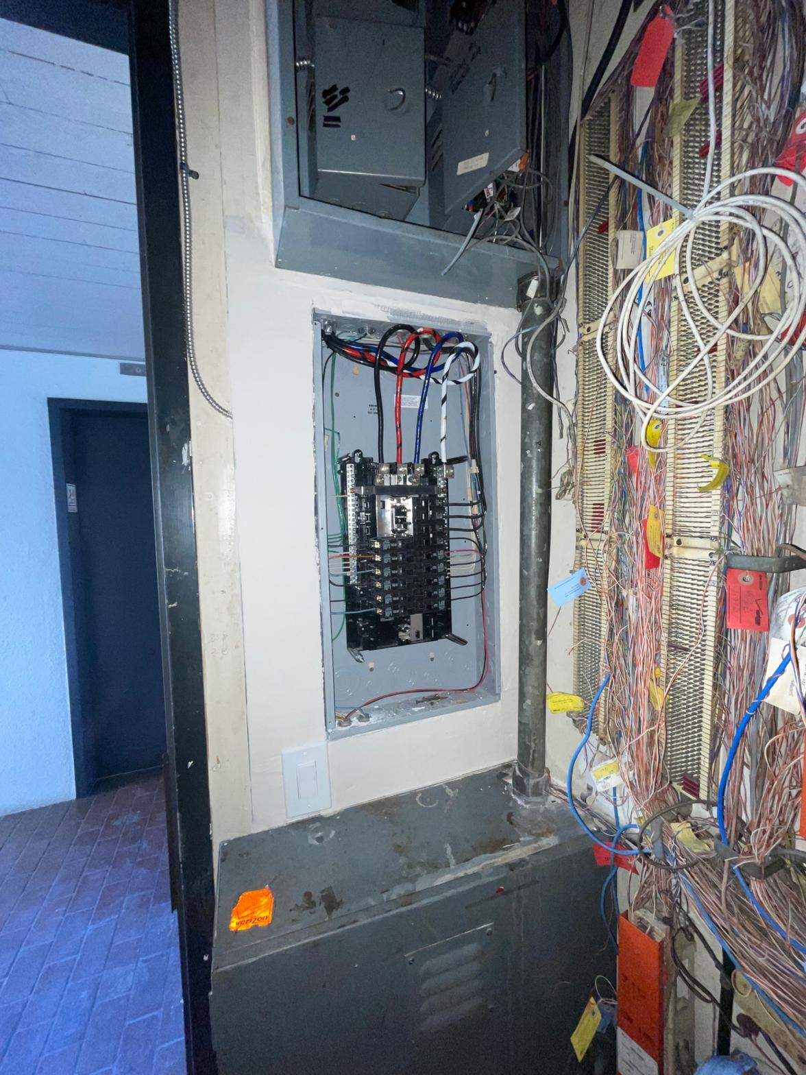 Electrical panel with exposed wiring — older panel requiring assessment by PMR Electrical