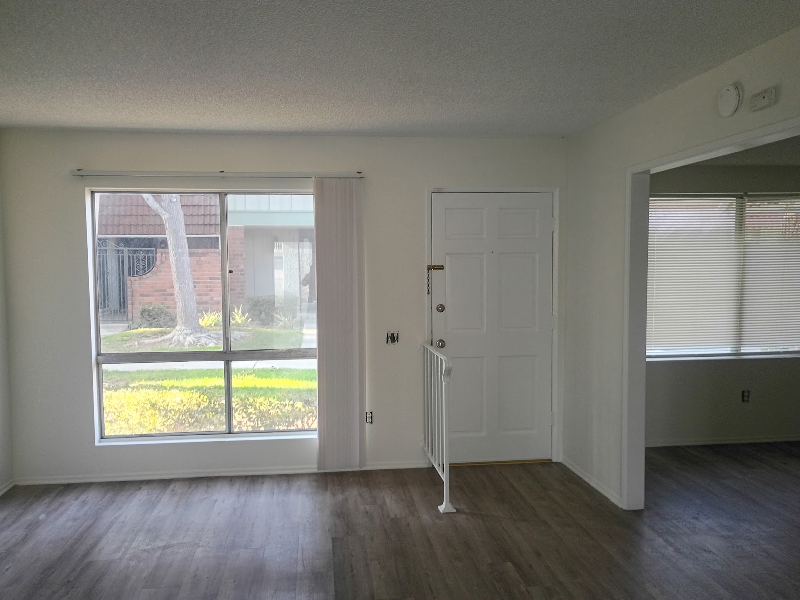 Interior painting - living room with front door and windows