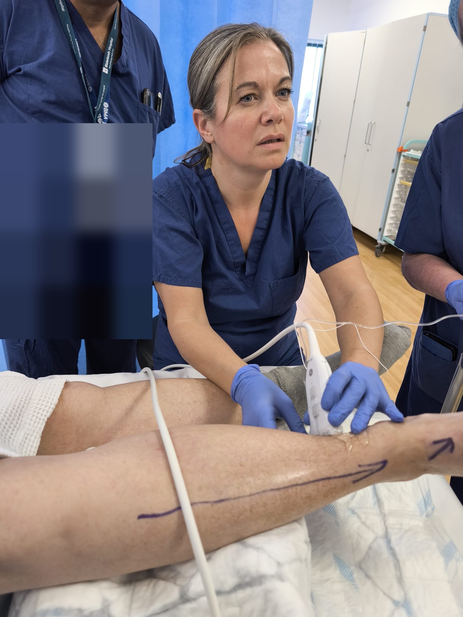 Sarah Treliving teaching ultrasound-guided ankle block technique to a consultant anaesthetist — NHS podiatric surgery setting